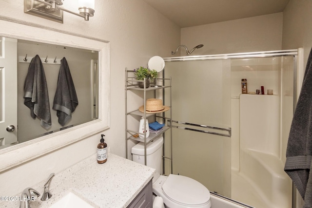 bathroom featuring toilet, a shower stall, and vanity