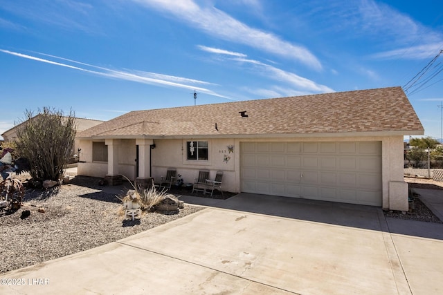 ranch-style home featuring a garage, a shingled roof, concrete driveway, and stucco siding