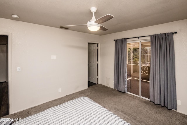 unfurnished bedroom featuring ceiling fan, access to outside, visible vents, and dark colored carpet