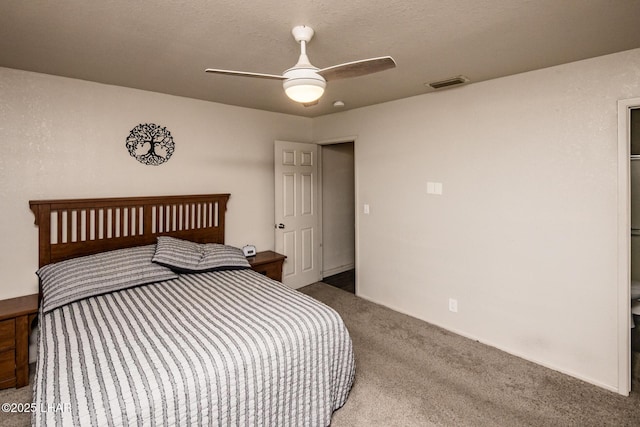 bedroom featuring a textured ceiling, ceiling fan, carpet, and visible vents