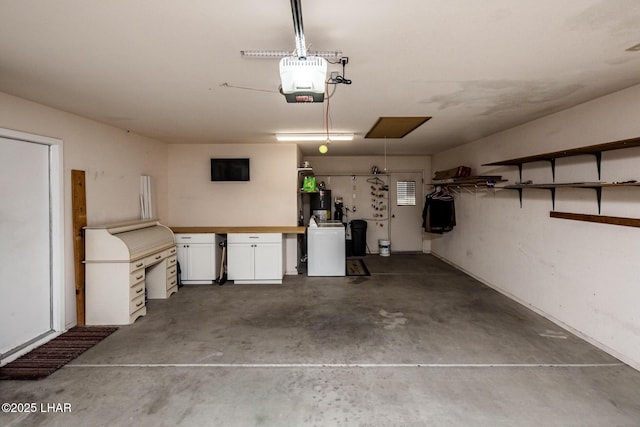 garage with washer / dryer, a workshop area, and a garage door opener