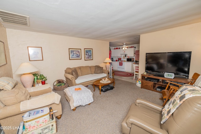 living room with carpet and visible vents