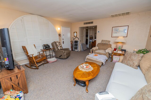 carpeted living area featuring visible vents