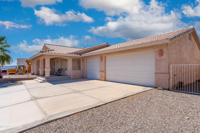 1607 Linda Dr, Lake Havasu City, AZ 86403 - view of front of house featuring an attached garage, stucco siding, a tiled roof, and concrete driveway
