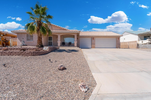 1607 Linda Dr, Lake Havasu City, AZ 86403 - view of front of home featuring a garage, concrete driveway, a tile roof, and stucco siding
