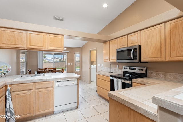1607 Linda Dr, Lake Havasu City, AZ 86403 - kitchen with appliances with stainless steel finishes, light brown cabinets, a sink, washer / clothes dryer, and a peninsula