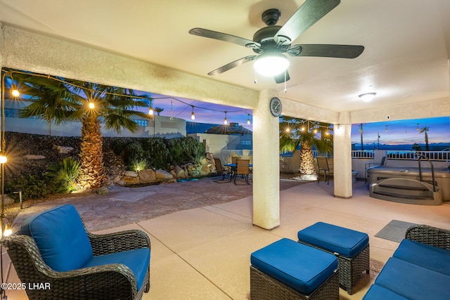 view of patio / terrace featuring outdoor dining area, fence private yard, a ceiling fan, and a hot tub