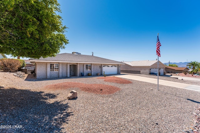 single story home featuring an attached garage and concrete driveway