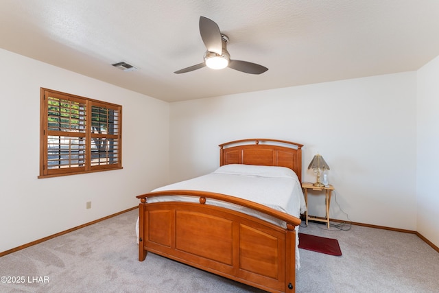 bedroom with light carpet, baseboards, a ceiling fan, and visible vents