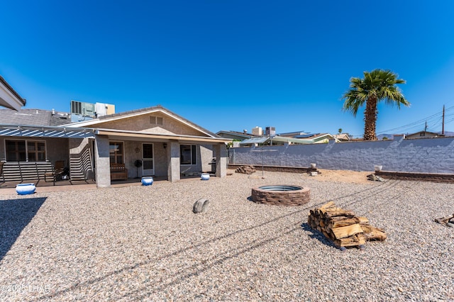 view of yard with a patio area, a fire pit, central air condition unit, and fence