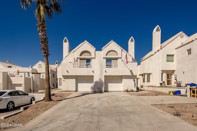 view of front of home with a garage and a balcony