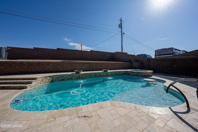 view of pool featuring a patio, pool water feature, and an in ground hot tub