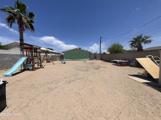 view of yard featuring fence and playground community