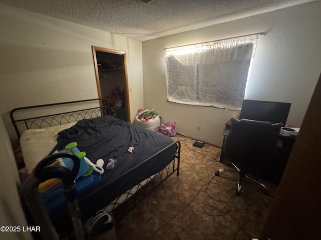 bedroom featuring a textured ceiling and carpet