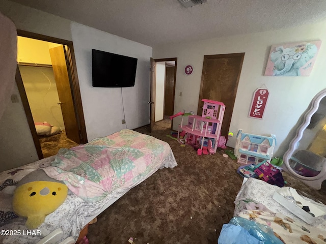 bedroom with a textured ceiling and carpet