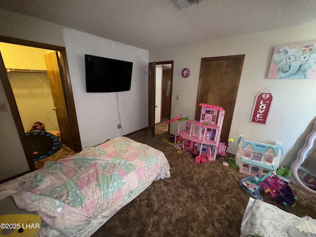 bedroom featuring carpet flooring and a textured ceiling