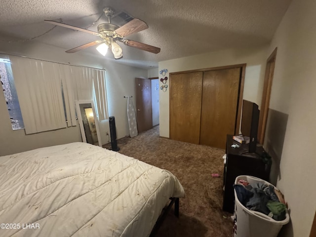 carpeted bedroom featuring a textured ceiling, ceiling fan, and a closet