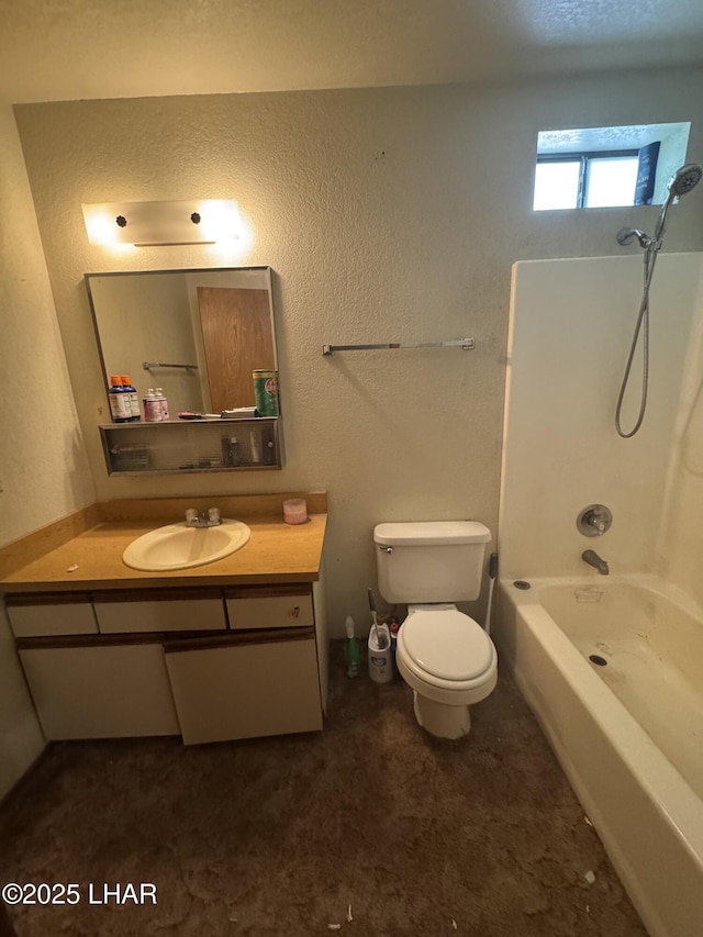 bathroom featuring vanity, washtub / shower combination, and toilet