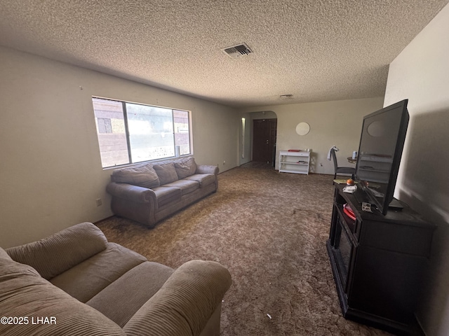 living room with carpet floors, arched walkways, a textured ceiling, and visible vents