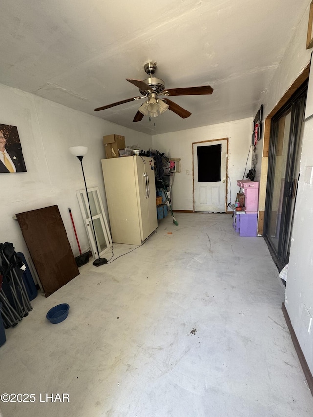 interior space with freestanding refrigerator and ceiling fan