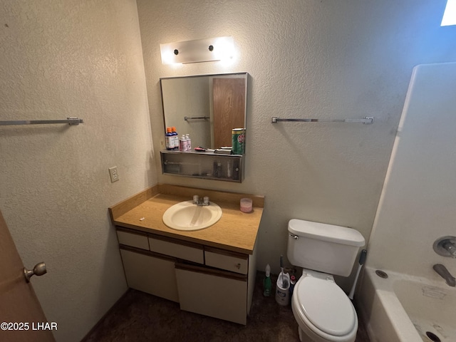 bathroom with vanity,  shower combination, and toilet