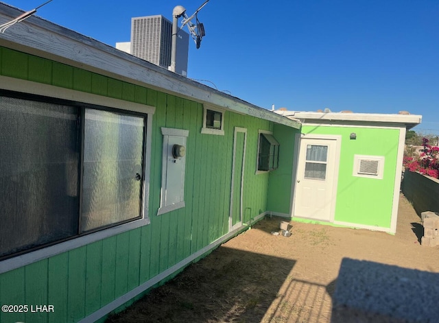 rear view of property with cooling unit