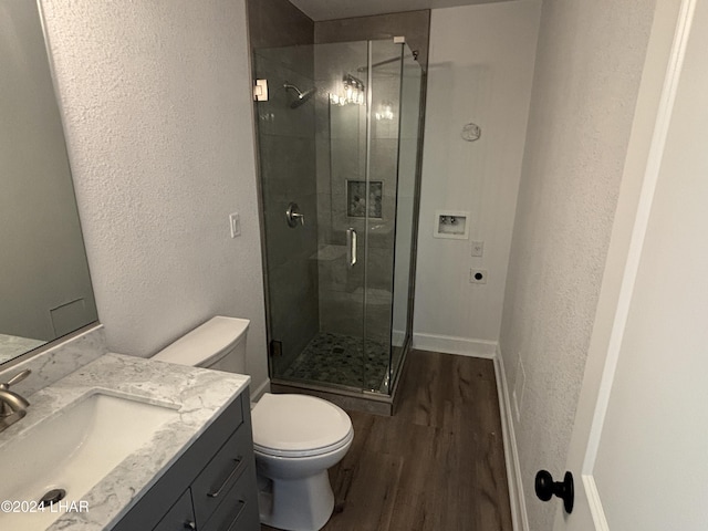 256 Lake Havasu Ave S Unit B75, Lake Havasu City, AZ 86403 - bathroom featuring hardwood / wood-style flooring, vanity, a shower with door, and toilet