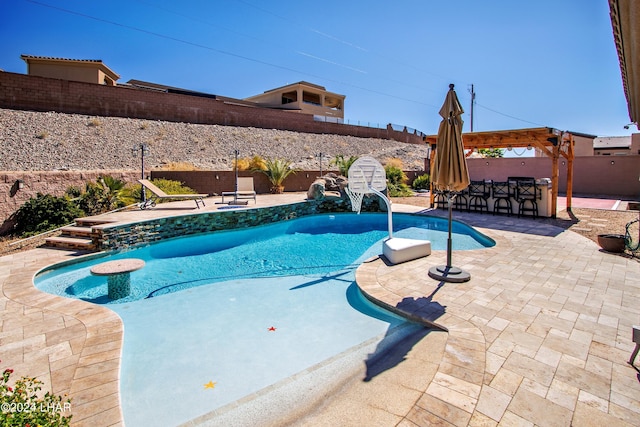 view of pool with a bar and a patio area