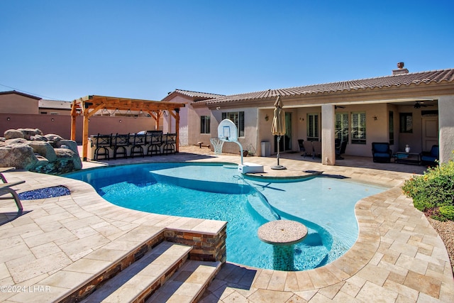 view of swimming pool featuring a patio, an outdoor bar, ceiling fan, and a pergola