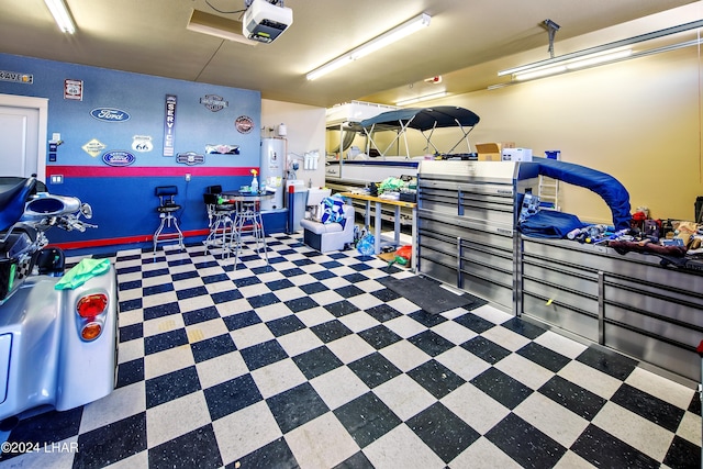 garage featuring a garage door opener and water heater