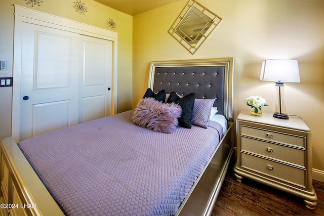 bedroom featuring dark hardwood / wood-style flooring and a closet