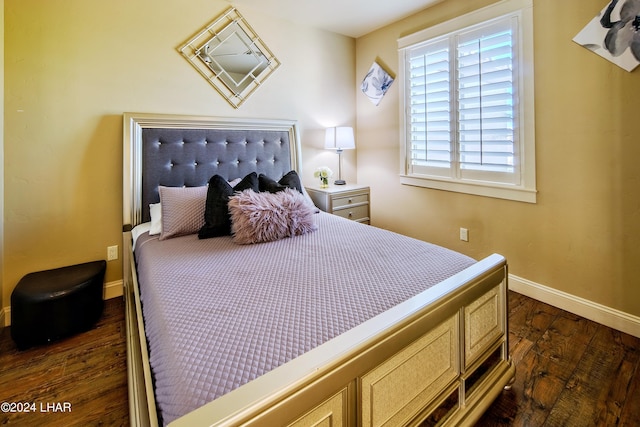 bedroom with dark hardwood / wood-style flooring