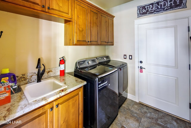 clothes washing area with cabinets, separate washer and dryer, and sink