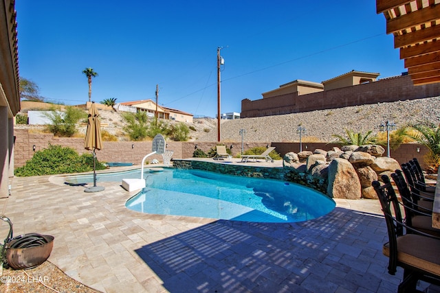 view of swimming pool with a patio