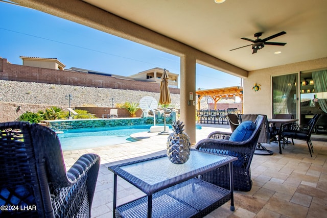 view of patio with a fenced in pool and ceiling fan