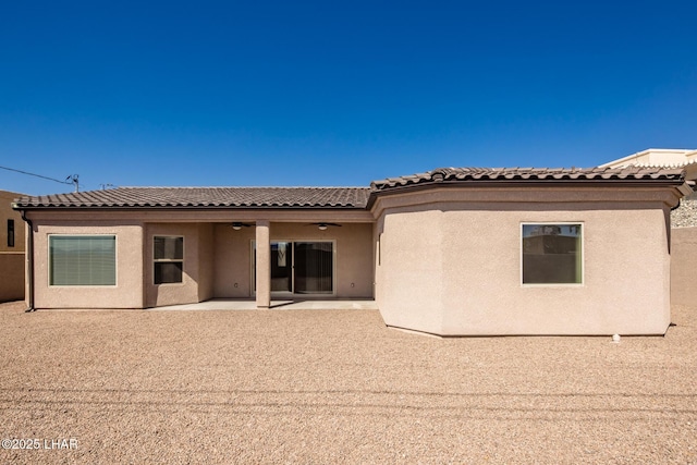 rear view of house featuring a patio, stucco siding, a tiled roof, and ceiling fan