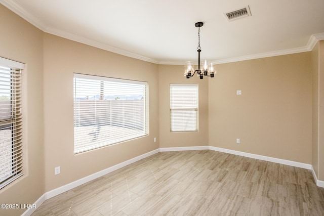 spare room featuring visible vents, a notable chandelier, ornamental molding, light wood-style flooring, and baseboards