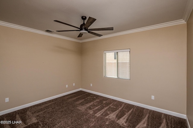 spare room featuring visible vents, dark carpet, baseboards, and crown molding