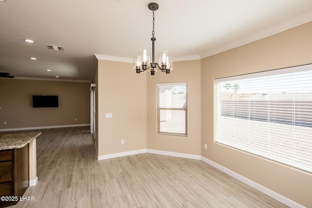 unfurnished dining area featuring light wood-type flooring, baseboards, visible vents, and ornamental molding