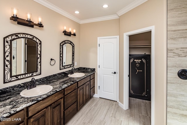 bathroom featuring double vanity, recessed lighting, ornamental molding, and a sink