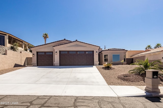 view of front of home featuring stucco siding, fence, concrete driveway, a garage, and a tiled roof