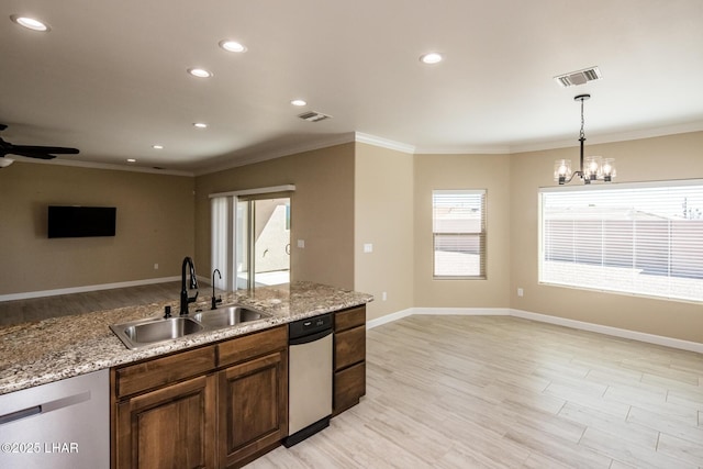 kitchen featuring visible vents, light wood-style flooring, a sink, dishwasher, and open floor plan