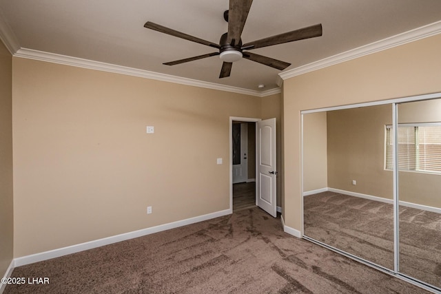 unfurnished bedroom featuring baseboards, carpet floors, ornamental molding, a closet, and a ceiling fan