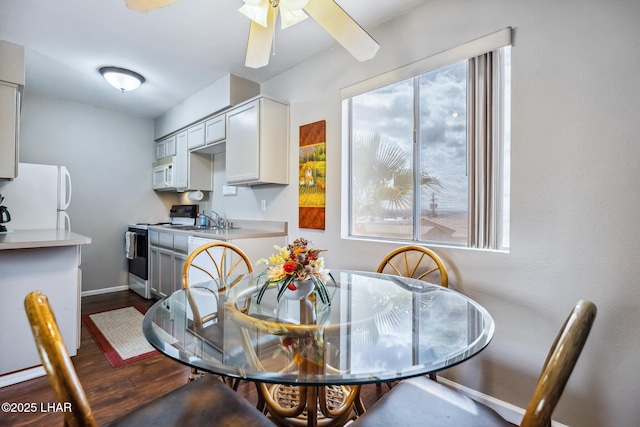 2100 Swanson Ave Unit 208, Lake Havasu City, AZ 86403 - dining area with dark wood finished floors, baseboards, and ceiling fan