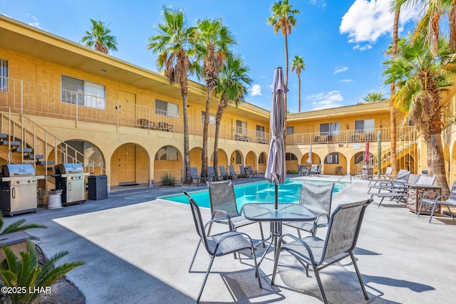 2100 Swanson Ave Unit 208, Lake Havasu City, AZ 86403 - community pool featuring a grill, stairs, and a patio area