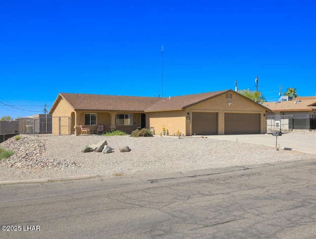 single story home with a garage, fence, concrete driveway, and stucco siding