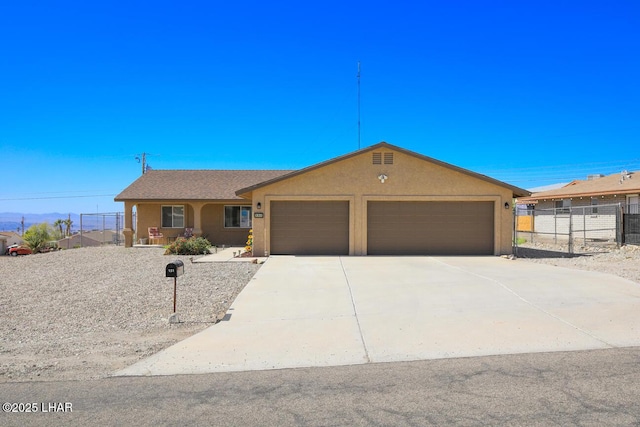 single story home featuring driveway, an attached garage, fence, and stucco siding