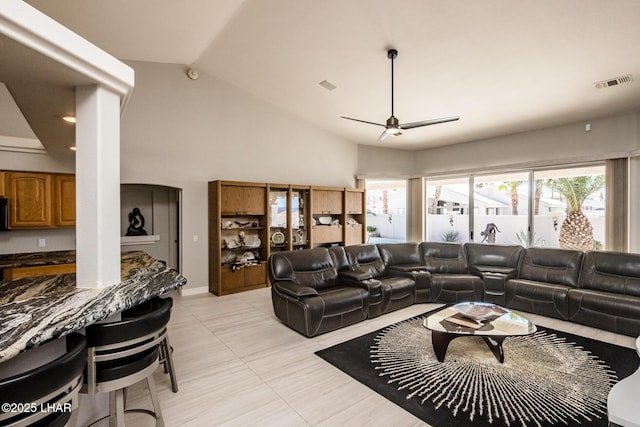 living room with ceiling fan, high vaulted ceiling, light tile patterned flooring, and visible vents