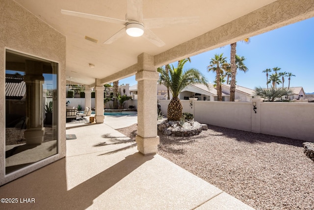 view of patio featuring a fenced backyard, a fenced in pool, and a ceiling fan