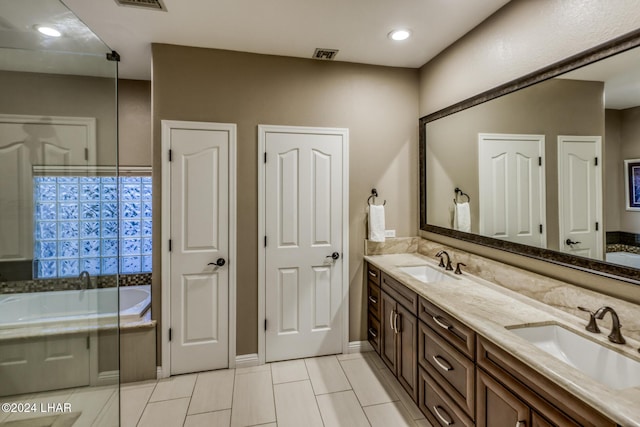 bathroom with vanity and a tub